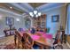 Formal dining room with hardwood table, chandelier and elegant decor at 9902 Craftsman Park Way, Palmetto, FL 34221