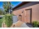 Exterior side view featuring an air conditioning unit, exterior door, and tropical landscaping at 9902 Craftsman Park Way, Palmetto, FL 34221