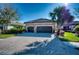 The front of a well maintained home with stone accents, paver driveway and a well manicured lawn at 9902 Craftsman Park Way, Palmetto, FL 34221