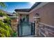 A gated front entryway with stone pillars and lush tropical plants and tile roof at 9902 Craftsman Park Way, Palmetto, FL 34221