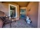 Cozy front porch with a seating area, stone bench, and a vibrant teal front door at 9902 Craftsman Park Way, Palmetto, FL 34221