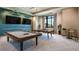 Modern game room featuring a pool table, ping pong table, wall decor, and comfortable seating at 9902 Craftsman Park Way, Palmetto, FL 34221