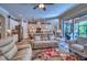 Open-concept living room featuring a sofa, and access to outdoor patio area at 9902 Craftsman Park Way, Palmetto, FL 34221