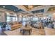 Large lounge area with comfortable seating, tables, dark wood floors and plenty of natural light at 9902 Craftsman Park Way, Palmetto, FL 34221