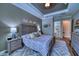 Cozy main bedroom with neutral tones, decorative pillows, and a view to main bathroom at 9902 Craftsman Park Way, Palmetto, FL 34221