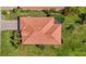 Roof aerial captures lush greenery and a screened-in patio off the back of the home at 10008 Carnoustie Pl, Bradenton, FL 34211