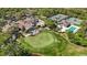 Expansive aerial shot highlighting the golf course, putting green, and clubhouse with outdoor seating area at 10008 Carnoustie Pl, Bradenton, FL 34211