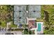 Overhead view showcases tennis courts and pool area with chairs at community recreation center at 10008 Carnoustie Pl, Bradenton, FL 34211