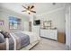 Bright bedroom with a ceiling fan, a TV and ample dresser storage space at 10008 Carnoustie Pl, Bradenton, FL 34211
