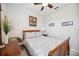 Cozy bedroom features a wooden bed frame, soft lighting, and calm artwork at 10008 Carnoustie Pl, Bradenton, FL 34211