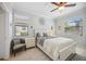Bright bedroom features a ceiling fan, two windows, and neutral paint at 10008 Carnoustie Pl, Bradenton, FL 34211