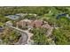 Aerial view of a clubhouse with manicured lawns, tennis courts, golf course, and inviting facilities at 10008 Carnoustie Pl, Bradenton, FL 34211