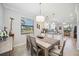 Dining area with natural light, tile flooring, seamlessly connected to the kitchen, ideal for entertaining at 10008 Carnoustie Pl, Bradenton, FL 34211