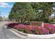 Rosedale Country Club entrance showcases colorful flowers and mature trees at 10008 Carnoustie Pl, Bradenton, FL 34211
