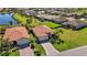 This immaculate home features manicured landscaping, brick driveway and sits near a calming community pond at 10008 Carnoustie Pl, Bradenton, FL 34211