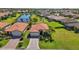 Inviting single-story home boasts lush landscaping, a brick driveway, and a serene neighborhood pond view at 10008 Carnoustie Pl, Bradenton, FL 34211