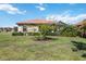 Landscaped backyard features a view of a screened-in lanai at 10008 Carnoustie Pl, Bradenton, FL 34211