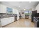 Bright and modern kitchen with granite countertops, white cabinets, and stainless steel appliances at 10008 Carnoustie Pl, Bradenton, FL 34211