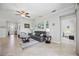 Open concept living room featuring neutral paint, tile floors, ceiling fan and large windows at 10008 Carnoustie Pl, Bradenton, FL 34211