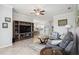 Spacious living room featuring tile floors, a ceiling fan, and an open layout leading to the dining area at 10008 Carnoustie Pl, Bradenton, FL 34211