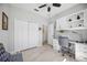 Bright office space boasts white built-in shelving, cabinets, and a desk with a white marble-look countertop at 10008 Carnoustie Pl, Bradenton, FL 34211
