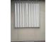 Beige accordion window shutter on a stucco house closes for security at 10008 Carnoustie Pl, Bradenton, FL 34211