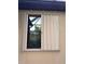 Beige accordion window shutter on a stucco house is partially open at 10008 Carnoustie Pl, Bradenton, FL 34211