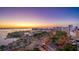 Stunning aerial view of a coastal community with a marina, beautiful buildings, and vibrant foliage at sunset at 101 S Gulfstream Ave # 16K, Sarasota, FL 34236