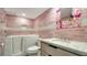 Accessible pink bathroom featuring a safe step-in tub, designer fixtures, and stylish vanity offering comfort and functionality at 101 S Gulfstream Ave # 16K, Sarasota, FL 34236