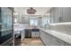 Bright kitchen featuring modern gray cabinetry, stainless steel appliances, and wood-look floors at 101 S Gulfstream Ave # 16K, Sarasota, FL 34236