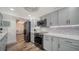 Updated kitchen with gray cabinets, modern appliances, and a view to the living room beyond at 101 S Gulfstream Ave # 16K, Sarasota, FL 34236