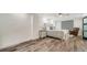 Bright bedroom featuring wood-look floors, tray ceiling, and a view to the ensuite bath at 101 S Gulfstream Ave # 16K, Sarasota, FL 34236