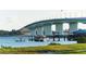Picturesque view of a waterfront pier with boats, a restaurant and a large bridge in the background at 101 S Gulfstream Ave # 16K, Sarasota, FL 34236
