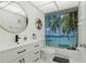 Updated bathroom features modern vanity with storage and framed mirror with a shower tub combo at 1216 58Th W St, Bradenton, FL 34209