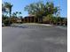 Well-manicured landscaping surrounds the community clubhouse and parking lot at 1216 58Th W St, Bradenton, FL 34209