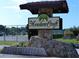 MeadowCroft community sign made of stone with a tennis court in the background at 1216 58Th W St, Bradenton, FL 34209