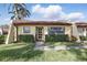 Inviting single-story villa featuring a red tile roof, lush landscaping, and a charming front entrance at 1216 58Th W St, Bradenton, FL 34209
