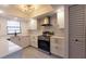 Modern kitchen featuring sleek white cabinets, stainless steel appliances, and elegant subway tile backsplash at 1216 58Th W St, Bradenton, FL 34209