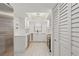 Bright, renovated kitchen boasts stainless steel appliances, light countertops, and stylish modern light fixture at 1216 58Th W St, Bradenton, FL 34209