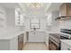 Modern kitchen featuring new stainless appliances, white cabinets, light countertops and contemporary lighting at 1216 58Th W St, Bradenton, FL 34209