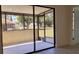 Covered porch with sliding glass doors, offering a seamless transition to the outdoor landscape at 1216 58Th W St, Bradenton, FL 34209