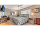 Comfortable bedroom with a large bed, soft blue bedding, a ceiling fan, and neutral wall colors providing a serene atmosphere at 131 Garfield Dr # 4D, Sarasota, FL 34236
