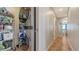 Efficient laundry area with stacked washer and dryer, complemented by hallway and tiled floors, ensuring practicality and style at 131 Garfield Dr # 4D, Sarasota, FL 34236