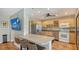 Well-equipped kitchen with stainless steel appliances and breakfast bar at 131 Garfield Dr # 4D, Sarasota, FL 34236