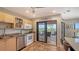 Modern kitchen with stainless steel appliances and sliding glass door to the balcony at 131 Garfield Dr # 4D, Sarasota, FL 34236