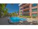 Inviting outdoor pool area with lounge chairs, surrounded by well-maintained landscaping, creating a perfect spot for relaxation at 131 Garfield Dr # 4D, Sarasota, FL 34236