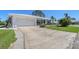 Charming single-story home with a two-car garage, well-manicured lawn, and a spacious concrete driveway at 1325 Bottlebrush Dr, Bradenton, FL 34208