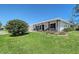 Single-story home with lush landscaping, covered front porch, and well-manicured lawn at 1325 Bottlebrush Dr, Bradenton, FL 34208