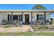 Welcoming front porch with seating, decorative plants, a wreath on the door, and a charming swan statue at 1325 Bottlebrush Dr, Bradenton, FL 34208