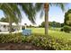 Scenic golf course view with a clubhouse, lush greenery, and clear skies, perfect for golf enthusiasts at 1325 Bottlebrush Dr, Bradenton, FL 34208
